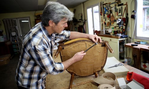 Upholsterer at work on a chair
