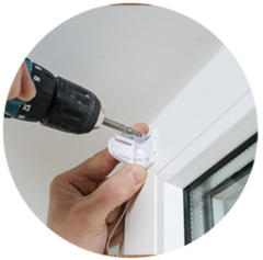 Installer fixing a shade bracket with a drill